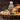 Bottle of Brooklane Almond Oil on a wooden surface with almonds and flowers.