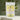 Instant Lemon Tea in a yellow package with tea granules in the background.