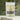 Lemongrass Tea in a fresh package with dried lemongrass and tea leaves in the background.