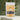 Orange Peoke Tea in a vibrant package with tea leaves in the background.